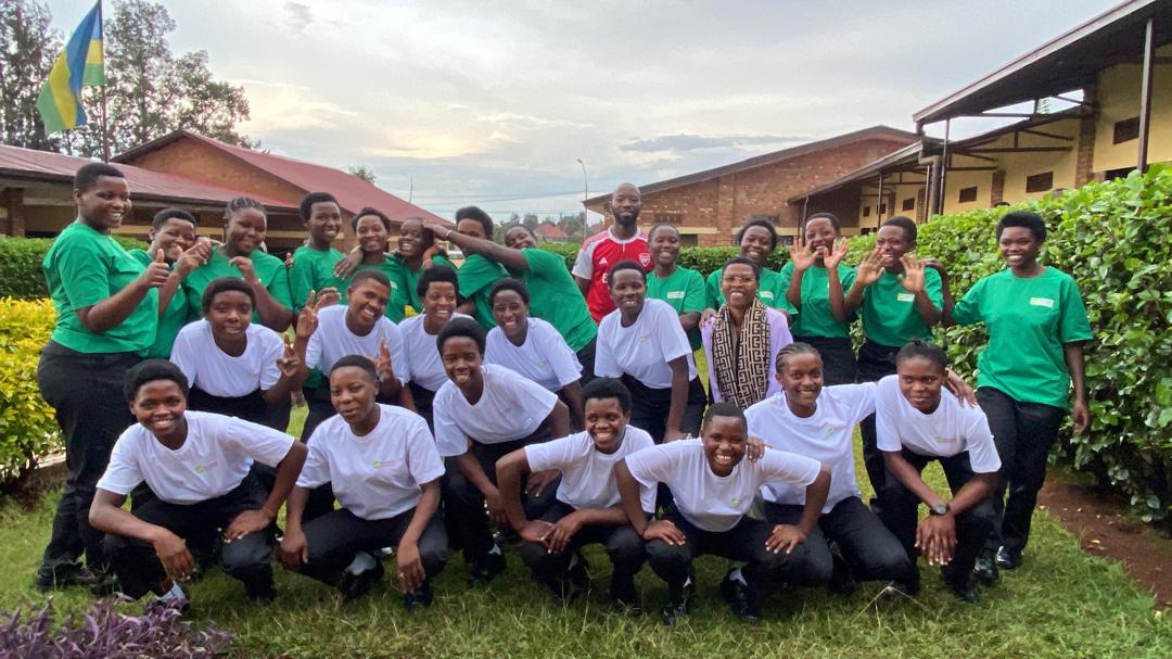 A group of students in front of their school